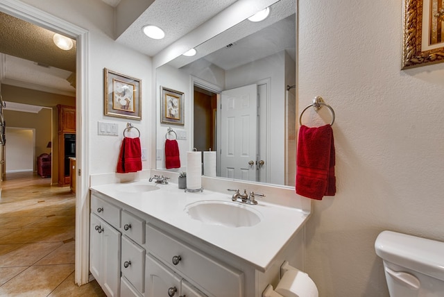 5500 Heartland Ct, Midland, TX 79707 - full bathroom with double vanity, a textured ceiling, and tile patterned floors