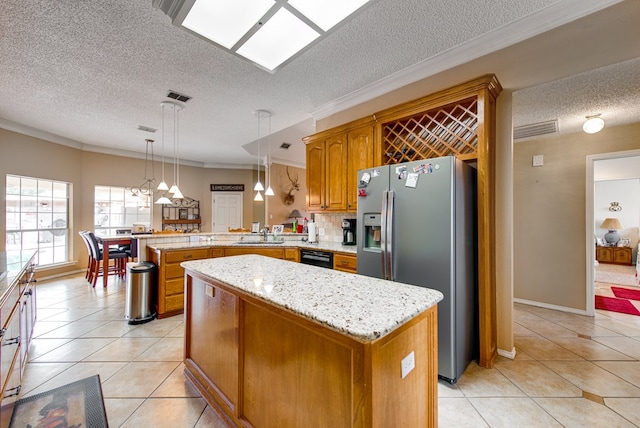5500 Heartland Ct, Midland, TX 79707 - kitchen with a textured ceiling, stainless steel fridge, a peninsula, light tile patterned floors, and brown cabinetry
