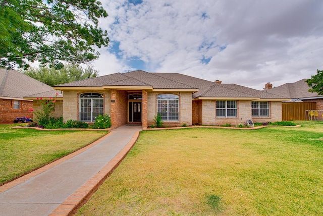 5500 Heartland Ct, Midland, TX 79707 - single story home with a front lawn, roof with shingles, and a chimney