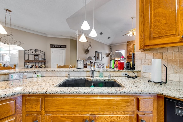 5500 Heartland Ct, Midland, TX 79707 - kitchen with a ceiling fan, light stone counters, brown cabinetry, and ornamental molding