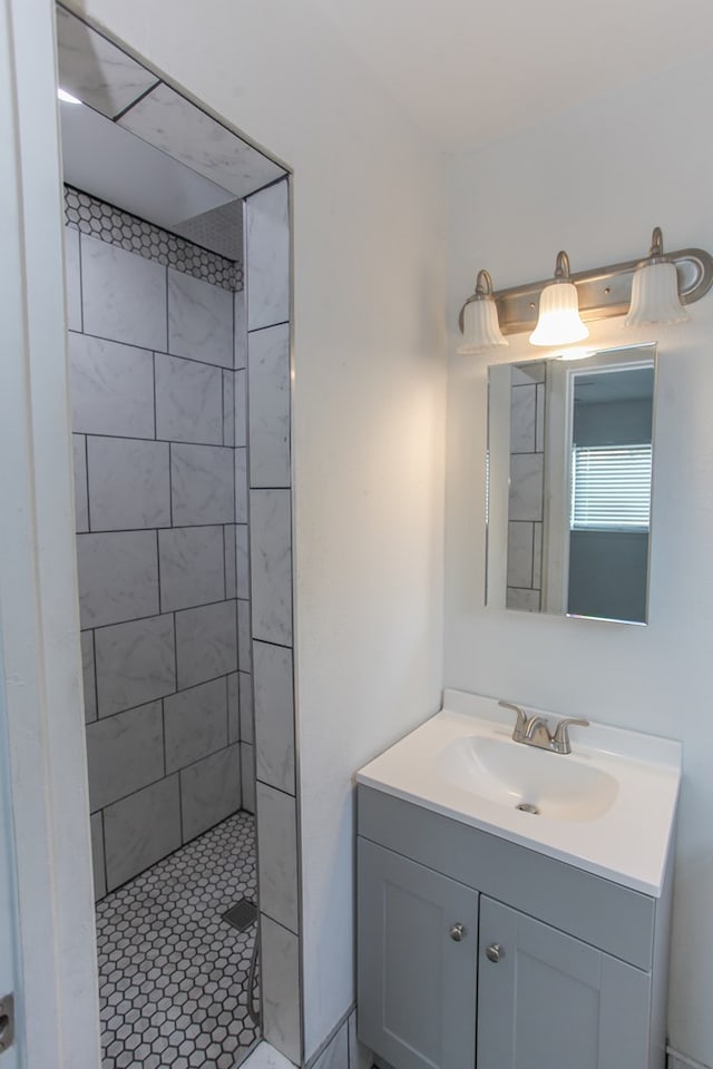 bathroom featuring vanity and tiled shower