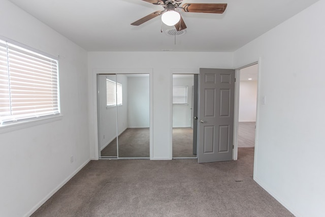 unfurnished bedroom with ceiling fan and carpet floors