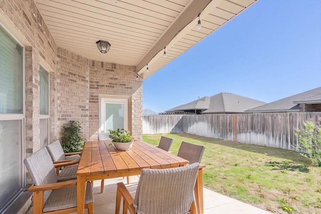 view of patio featuring outdoor dining space and a fenced backyard