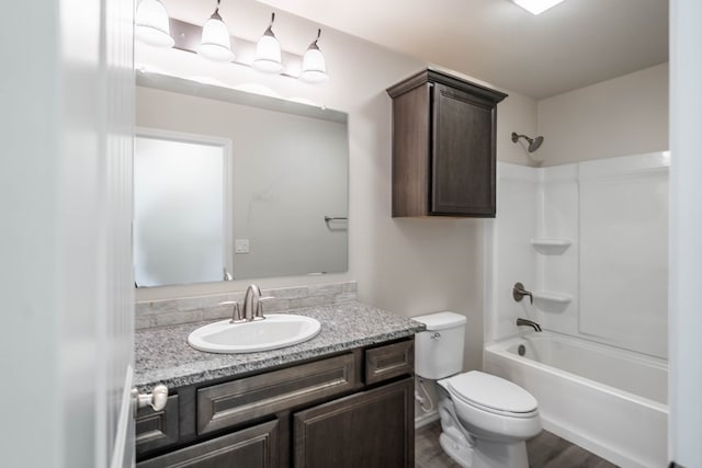 full bathroom with toilet, bathing tub / shower combination, and vanity