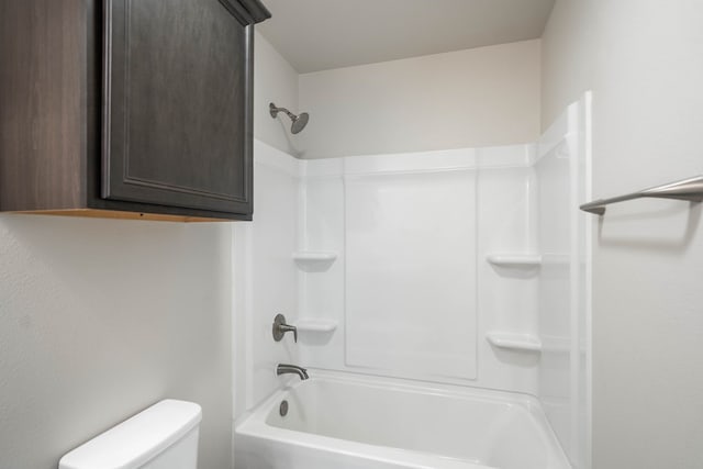 bathroom with shower / bathing tub combination and toilet