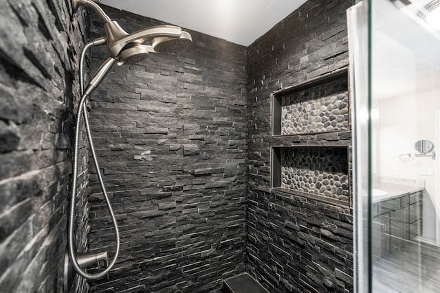 bathroom with a tile shower