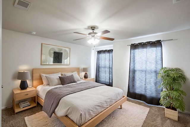 carpeted bedroom featuring visible vents and ceiling fan