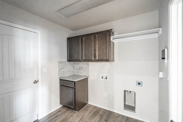 laundry area featuring hookup for a washing machine, baseboards, light wood-type flooring, cabinet space, and electric dryer hookup