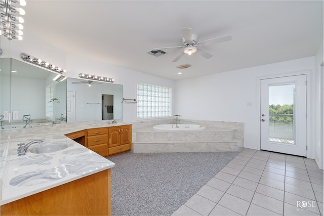 bathroom with a wealth of natural light, tile patterned flooring, and ceiling fan