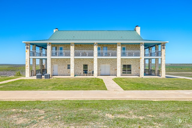 exterior space featuring central AC and a yard