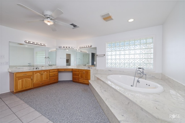 bathroom featuring tile patterned floors, tiled bath, ceiling fan, and vanity