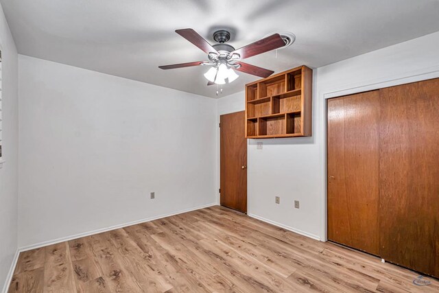 2310 W Shandon Ave, Midland, TX 79705 - unfurnished bedroom with light wood-type flooring, a closet, and baseboards