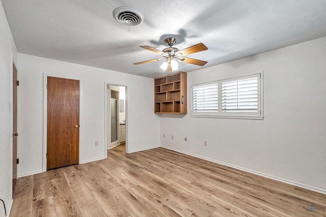 2310 W Shandon Ave, Midland, TX 79705 - unfurnished bedroom featuring light wood finished floors, baseboards, ensuite bath, and a ceiling fan