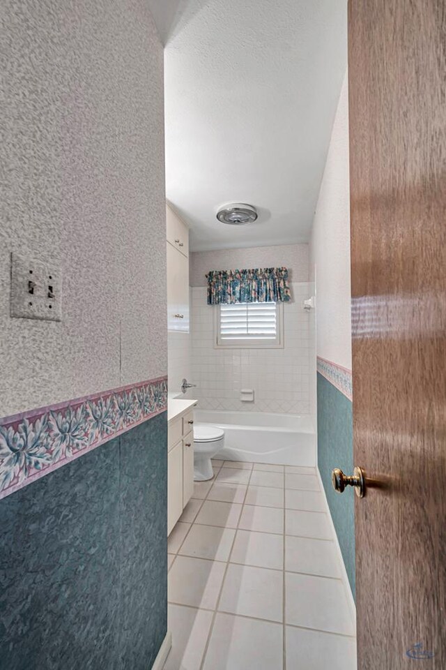 2310 W Shandon Ave, Midland, TX 79705 - bathroom with tile patterned flooring, toilet, vanity, and washtub / shower combination
