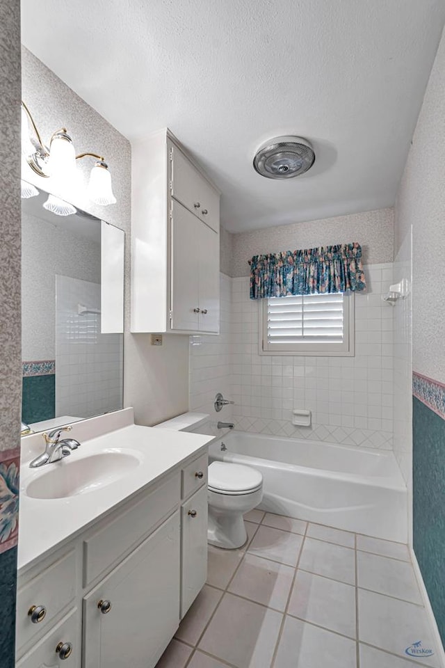 2310 W Shandon Ave, Midland, TX 79705 - full bath with tile patterned floors, vanity, toilet, a textured ceiling, and  shower combination