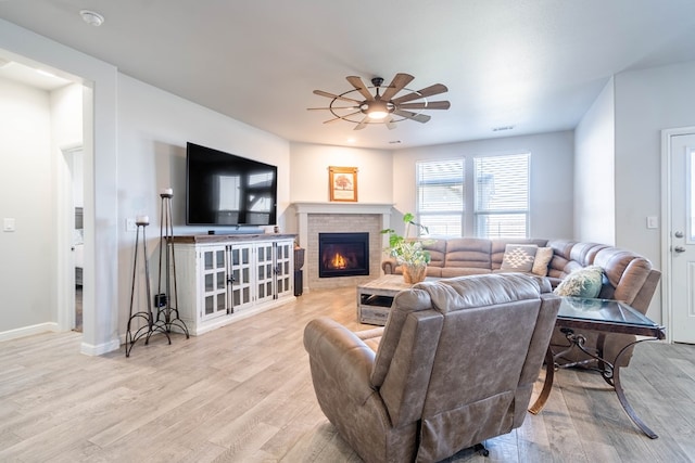 living room with ceiling fan and light hardwood / wood-style floors