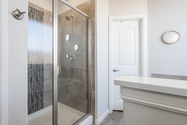 bathroom featuring a shower with door