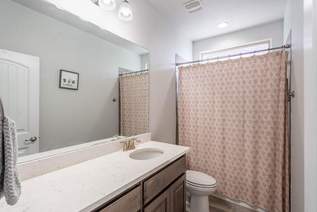 bathroom featuring hardwood / wood-style floors, vanity, toilet, and a shower with curtain