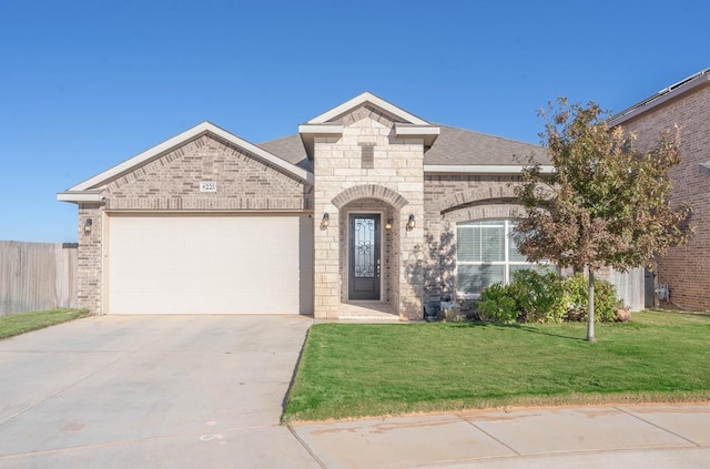 view of front of house with a front lawn and a garage