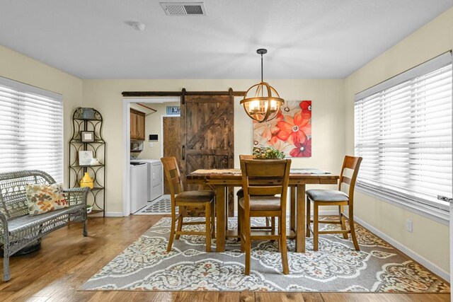 6413 Piedmont Dr, Odessa, TX 79762 - dining area featuring a barn door, independent washer and dryer, healthy amount of natural light, and a chandelier