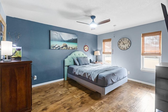 6413 Piedmont Dr, Odessa, TX 79762 - bedroom featuring multiple windows, wood finished floors, and ceiling fan