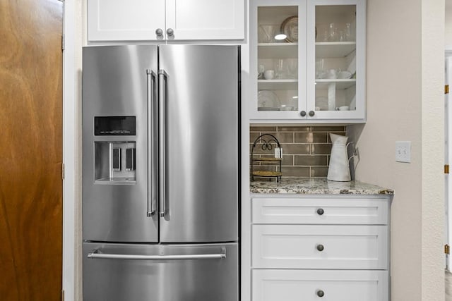 6413 Piedmont Dr, Odessa, TX 79762 - kitchen with high quality fridge, backsplash, glass insert cabinets, and white cabinets