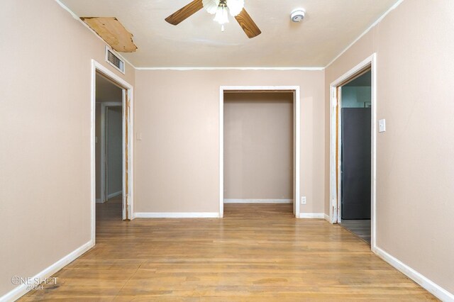 spare room featuring light wood-type flooring and ceiling fan