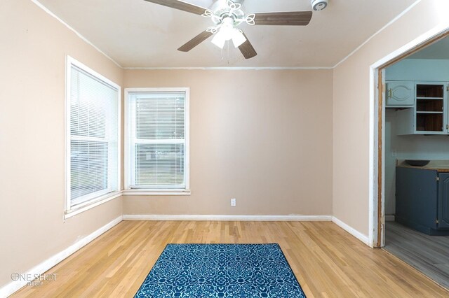 empty room featuring ceiling fan, wood-type flooring, and ornamental molding