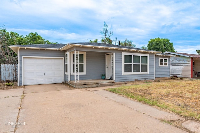 single story home featuring covered porch, a garage, and a front lawn