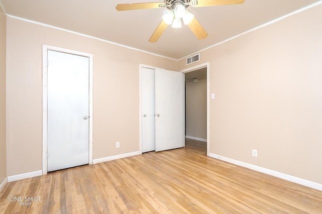 unfurnished bedroom with ceiling fan, light hardwood / wood-style floors, and crown molding