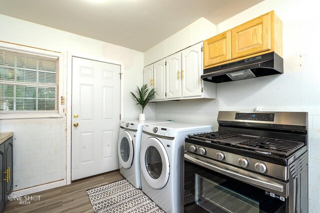 laundry room featuring washer and dryer and dark hardwood / wood-style floors