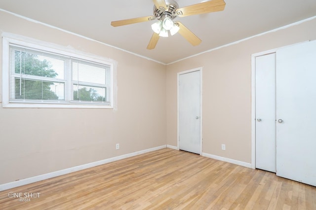 unfurnished bedroom featuring ceiling fan, light hardwood / wood-style flooring, and crown molding