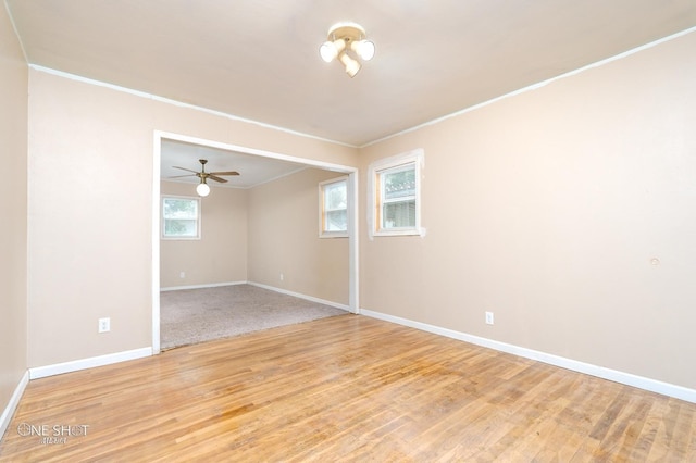 unfurnished room with ceiling fan, light hardwood / wood-style floors, and ornamental molding