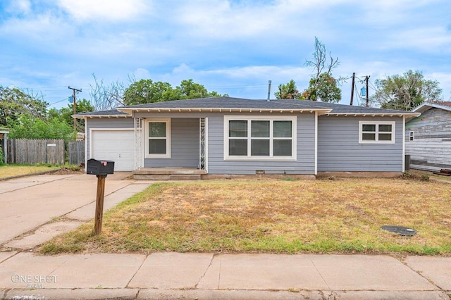 ranch-style home with a front lawn and a garage