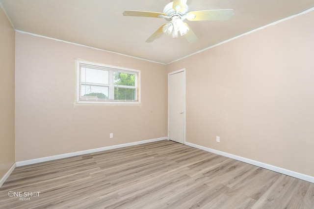 spare room featuring ceiling fan, light hardwood / wood-style floors, and crown molding