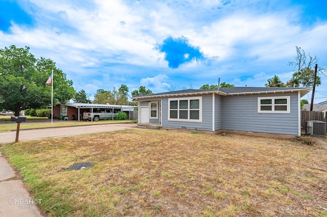 ranch-style home featuring central AC unit and a front lawn