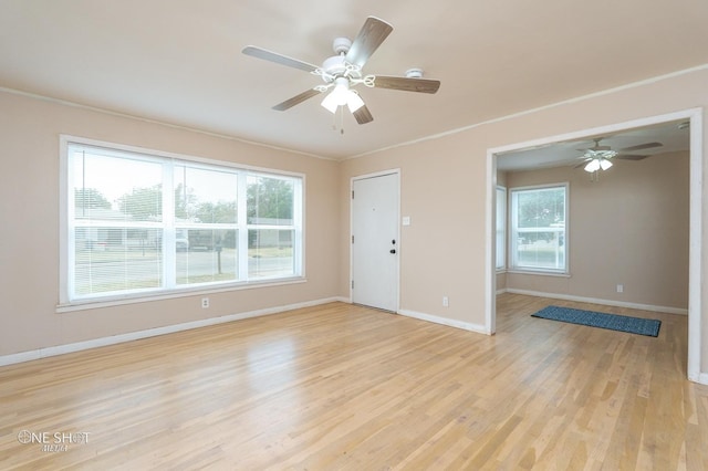 unfurnished room with ceiling fan, crown molding, and light hardwood / wood-style floors