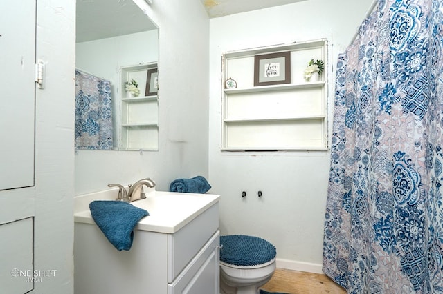 bathroom with vanity, wood-type flooring, and toilet