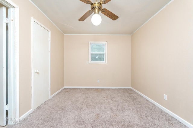 unfurnished room with light colored carpet, ceiling fan, and crown molding