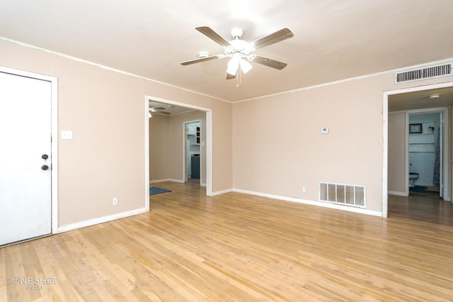 unfurnished room featuring light hardwood / wood-style floors, ceiling fan, and crown molding