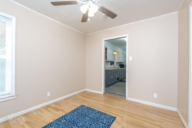 spare room with hardwood / wood-style floors, plenty of natural light, and ornamental molding