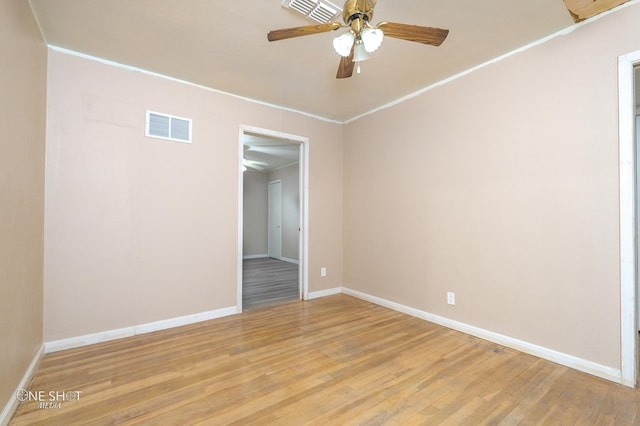 spare room featuring ceiling fan, crown molding, and light hardwood / wood-style flooring