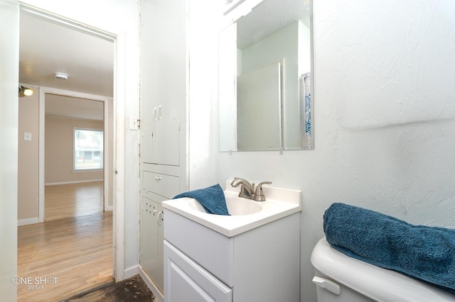 bathroom featuring vanity, toilet, and wood-type flooring