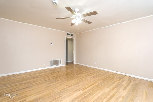 spare room featuring light hardwood / wood-style floors, ceiling fan, and ornamental molding