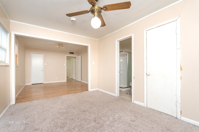 spare room with light carpet, ceiling fan, and ornamental molding