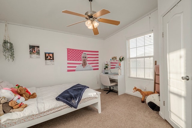 bedroom featuring light colored carpet, ceiling fan, and crown molding