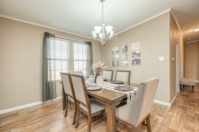 dining area with a chandelier, crown molding, and light hardwood / wood-style floors