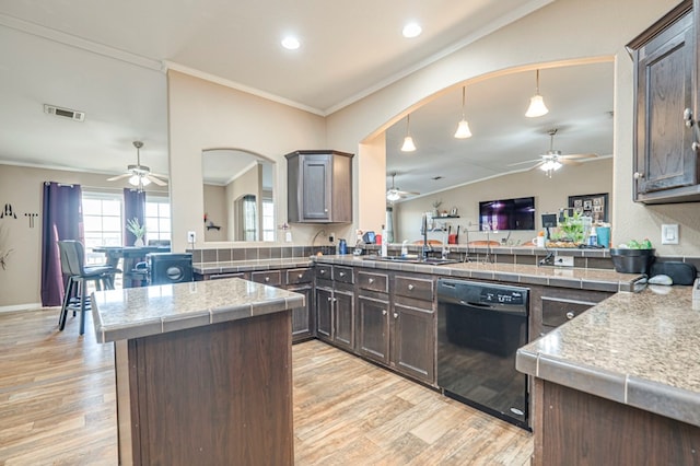 kitchen with kitchen peninsula, dark brown cabinets, and black dishwasher