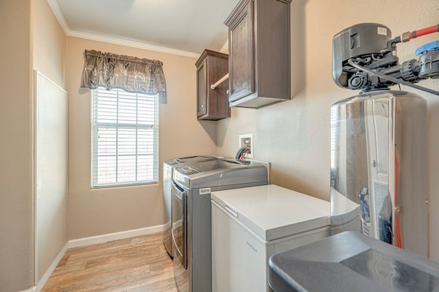 laundry room featuring cabinets, independent washer and dryer, light hardwood / wood-style floors, and crown molding