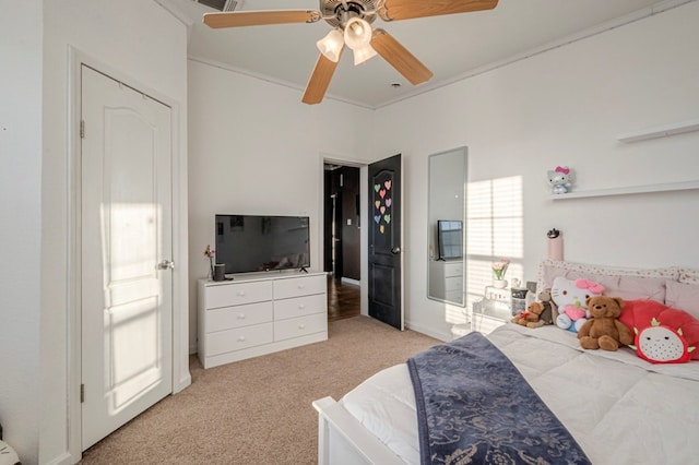 bedroom with ceiling fan, ornamental molding, and light carpet